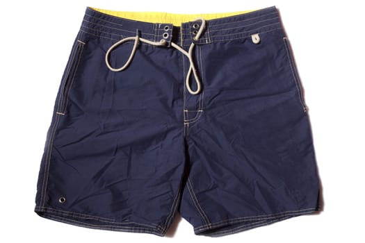 mens blue swimming trunks on a white background