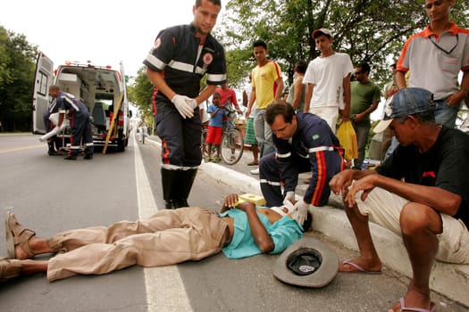 porto seguro, bahia / brazil - october 5, 2010: rescuers from Samu 192 provide assistance to an injured person on the BR 367 highway in the city of Porto Seguro, in southern Bahia..