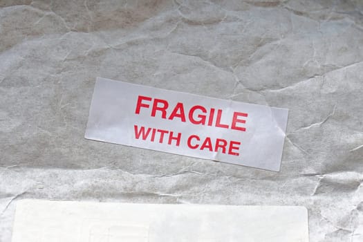 Fragile with care sticker at mail post