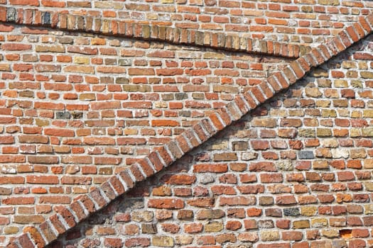 Old red brickwork walls with diagonal lines