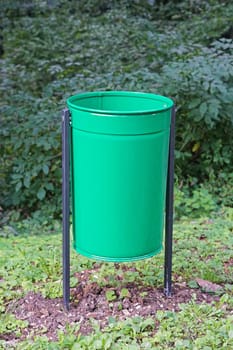 Green litter waste bin in city park