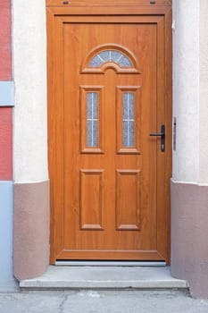 Brown wood door with big transom light window