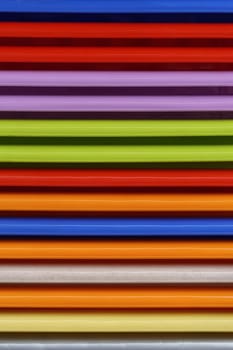 Stacked colourful plastic parts repetitive pattern