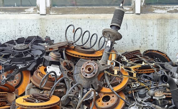 Pile of old car parts scrap metal for recycling