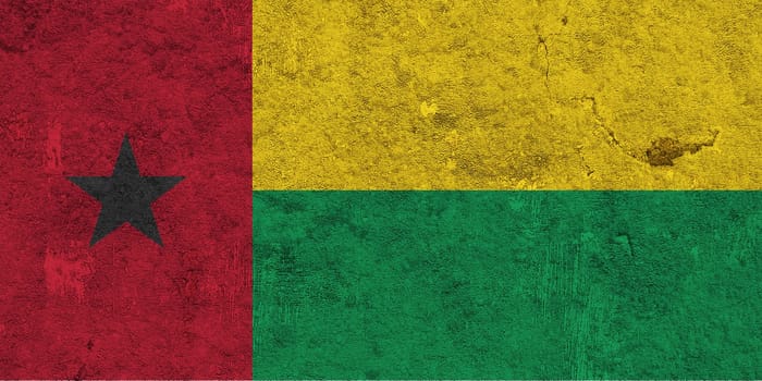 Flag of Guinea-Bissau on weathered concrete