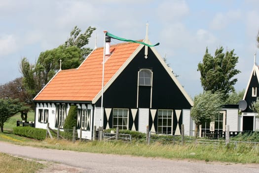 a little lonely farmhouse, blue sky in the background