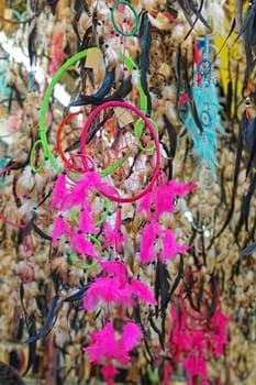 Native American culture dream catcher feathers in pink