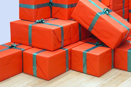 Big stack of red gifts with green ribbon