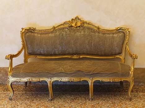 Classic style golden sofa with patina
