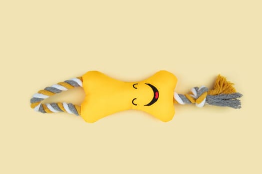 Funny Dog Toy with a face on yellow background