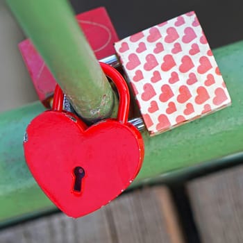 Love locks in shape of heart attached at bridge
