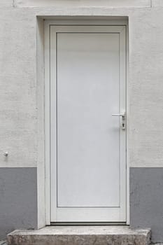 Closed white door at house exterior