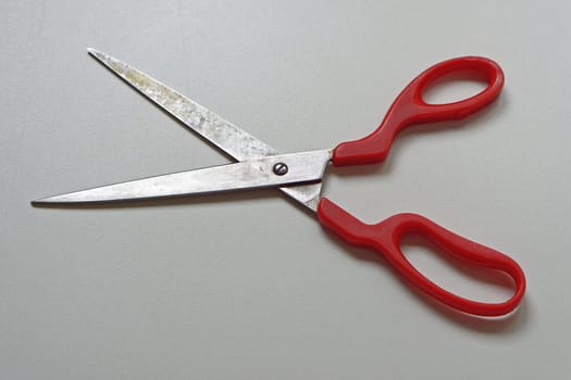 Long scissors with sharp edge and red handles