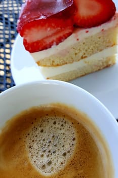 Coffee break with a cup of coffee and strawberry cake