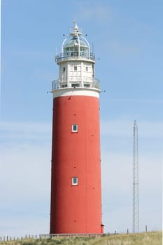 red lighthouse with blue sky in the background.