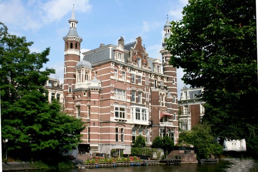 large, multi-story building on a canal