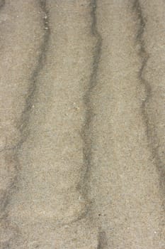 a wavy pattern in beige sand.