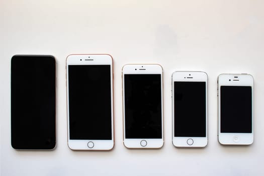 Calgary, Alberta, Canada. Aug 22, 2020. Several iPhone screens from view on a white background.