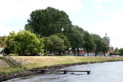 a small wooden jetty along a small river.