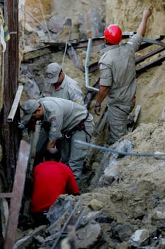 eunapolis, bahia / brazil - march 2, 2011: members of the fire department rescue a worker buried in a ditch for sewage in the city of Eunapolis.