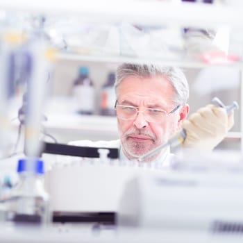 Life scientist researching in laboratory. Life sciences study living organisms on the level of microorganisms, viruses, human, animal and plant cells, genes, DNA...