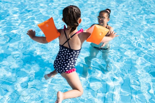 Child Jumping In Swimming Pool In Summer