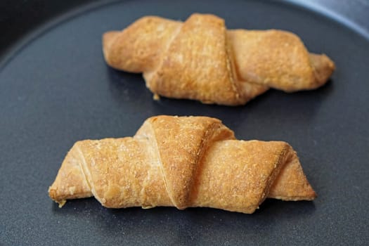 Two croissants french pastry at tray