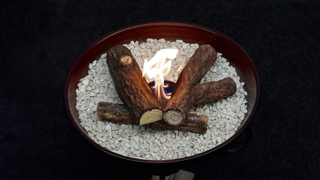 Artificial fire in decorative tray at home