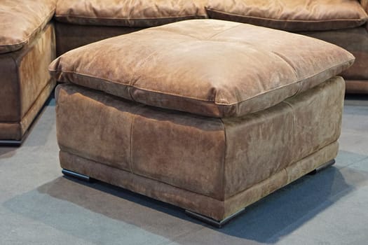 Big leather footstool in living room