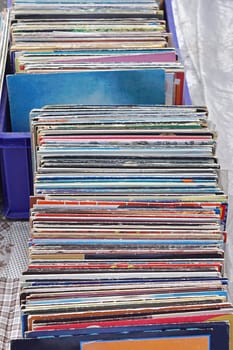 Stacked second hand vinyl records at flea market