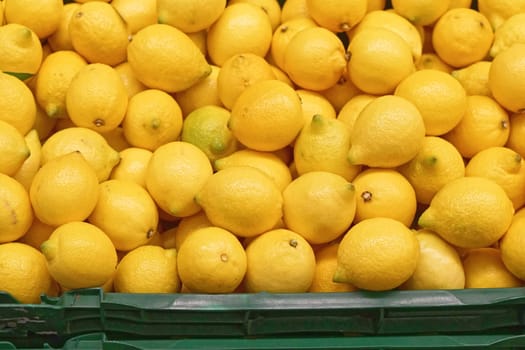 Big bunch of yellow lemons in crate