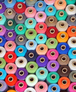 Colorful sewing threads and yarns at bobbins