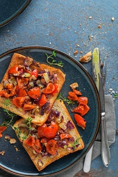 Vegetarian snack appetizer with tomatoes and onion on roasted bread , top view. Healthy food concept.