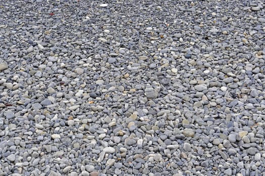 Big pebbles at beach texture background