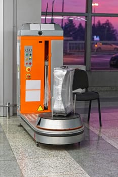 Plastic wrap luggage machine at airport