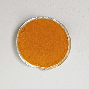 Tumeric spice in small round package