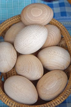 Big bunch of wooden eggs in basket