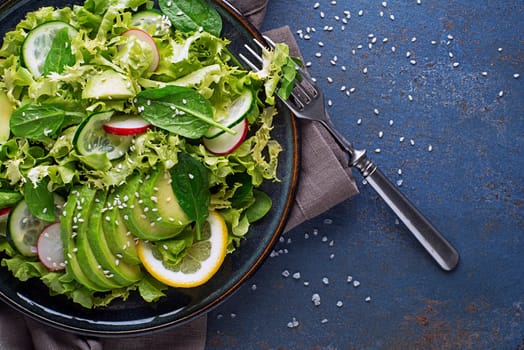 Healthy Green salad with avocado fresh light vegetables close up