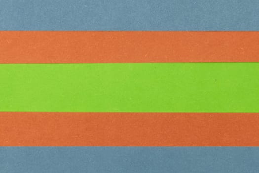 Green, Orange and Blue coloured paper background, abstract contrast conceptual image