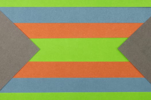Green, Orange, Blue and Grey coloured paper background, abstract contrast conceptual image