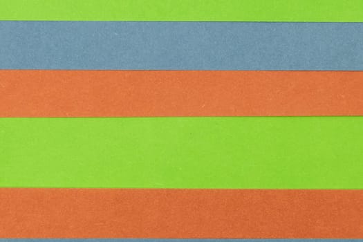Green, Orange and Blue coloured paper background, abstract contrast conceptual image