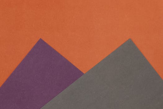 Grey, Purple and Orange coloured paper background, abstract contrast conceptual image