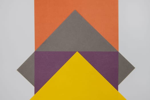 Grey, Purple, Orange and Yellow coloured paper background, abstract contrast conceptual image