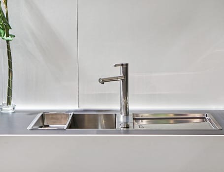 Modern sink with faucet in white kitchen
