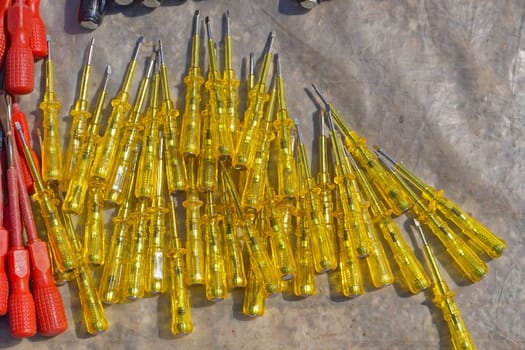 Big bunch of yellow tester voltage screwdrivers