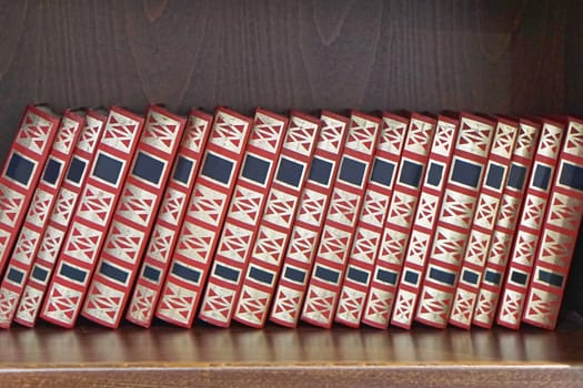 Books collection at wooden book shelf