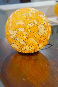 Table lamp with yellow glass bulb sphere