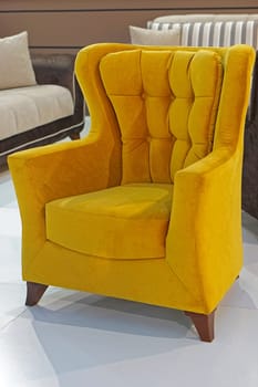 Bright plush textile armchair in room