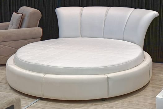 Modern white leather round bed in bedroom