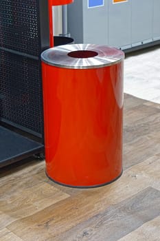 Modern round red trash can in office